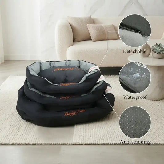 A stack of three black orthopedic pet beds on a beige rug in a living room setting, with three circular callout insets showing close-up feature details: a detachable zipper, waterproof coating, and anti-skidding texture.